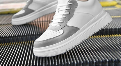 Lift Sneakers in white and gray, worn on an escalator