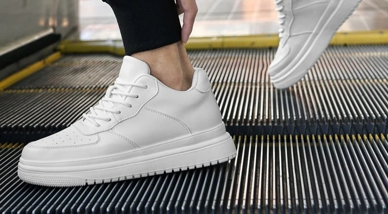 Lift Sneakers in white, worn on an escalator